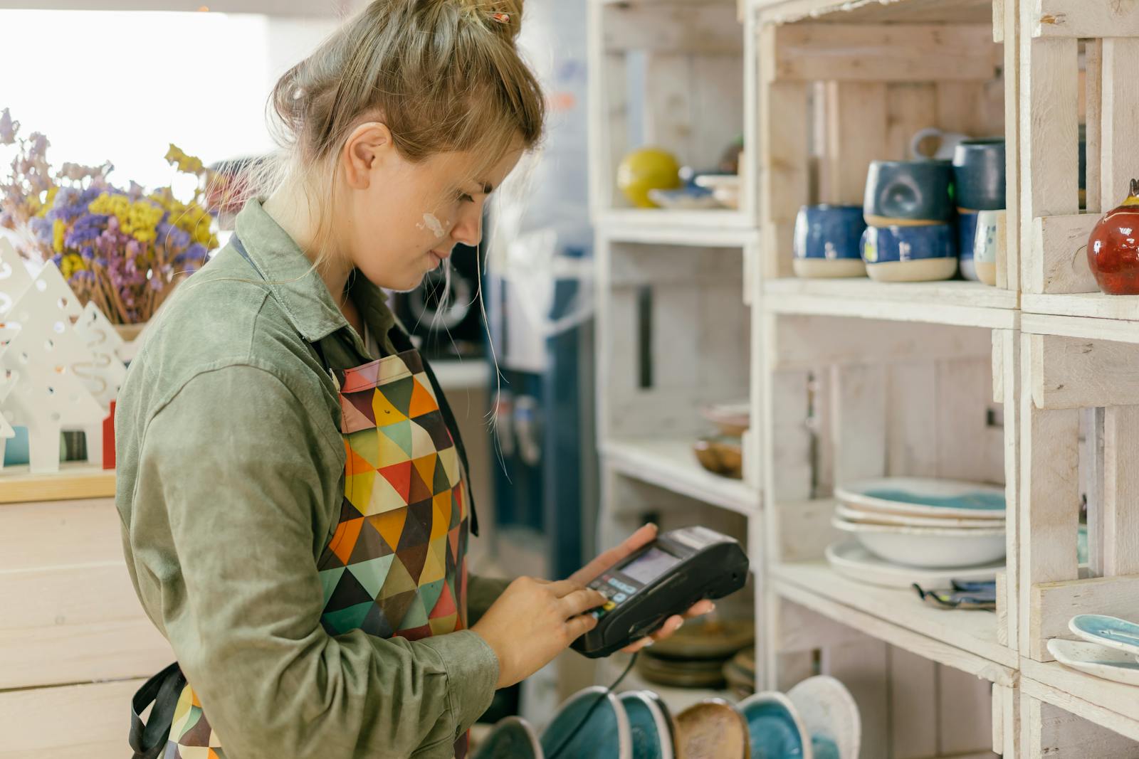 Photo of a Woman Holding a Pos Machine