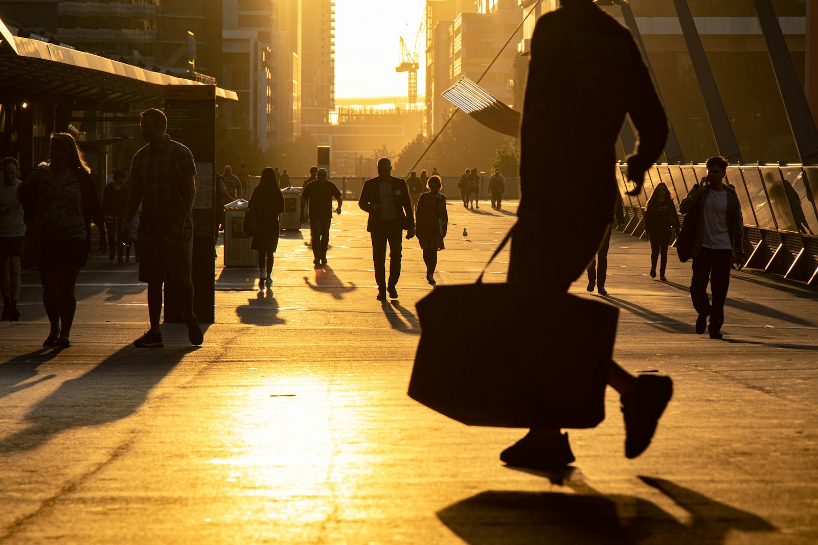 man walking on the field carrying bag